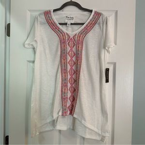 1X white cap-sleeve tee with bright geometric pattern embroidery